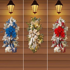 Three teardrop Christmas wreaths with LED lights in blue, gold and red for stair decor