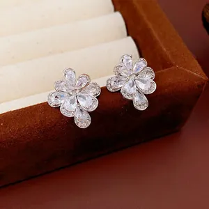 Exquisite silver floral stud earrings with drop-shaped zircon crystals on velvet box