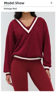 Detail of vintage red sports sweatshirt with striped V-neck and ribbed cuffs design
