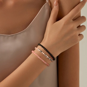 Close-up of 4mm natural stone beaded bracelet set on wrist with amethyst accents