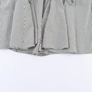 Close-up of black and white checkered fabric with natural cotton texture and weave