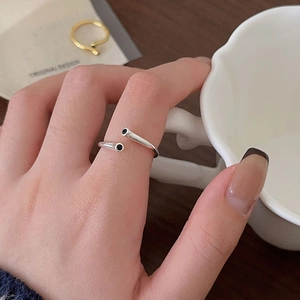 Detail of 925 sterling silver open ring with black zircon studs worn on a finger
