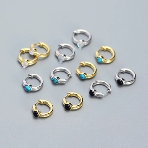 Detailed macro view of S925 silver huggie earrings with colorful turquoise inlays