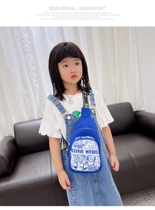 Detail of blue nylon kids chest bag with cartoon print and adjustable strap on child