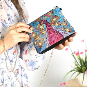 DIY diamond painting crossbody bag with vibrant peacock pattern and gold chain strap