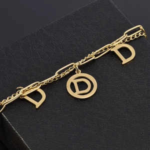 Double-layered gold bracelet with hollow D-letter pendants and paperclip chain links