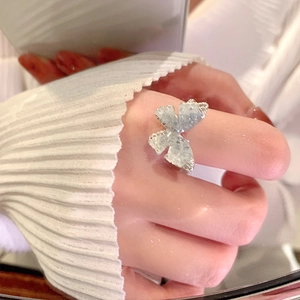Close-up of butterfly ring with ice-crack texture on finger for elegant women style