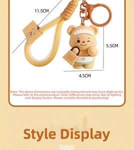 Detail view of cartoon cream bear keychain showing dimensions 5.5cm tall with woven strap
