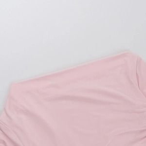 Detailed macro view of the soft pink fine knit fabric texture of this long sleeve top