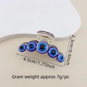 Detail of blue evil eye hair claw clip with 4.5cm length and dimensions for styling