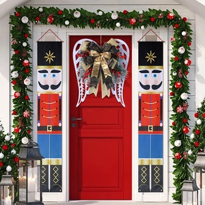 Christmas wreath door hanging with Nutcracker banners and decorative angel wing bow