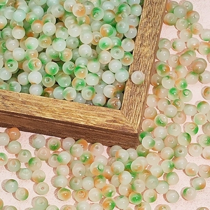 Detail shot of multi-color gradient glass beads in a wooden box for DIY jewelry making
