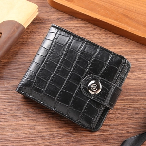 Detailed close-up of retro black crocodile pattern leather wallet with metal snap button