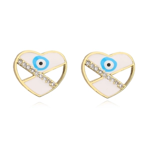 Detail view of heart-shaped evil eye stud earrings with gold plating and blue enamel