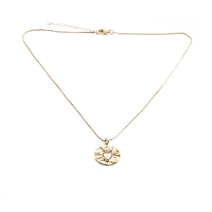 Close-up of gold-plated Sacred Heart pendant with sparkling crystals on a fine chain