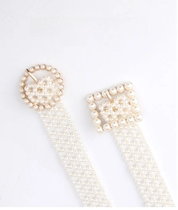 Close-up of elegant pearl waist chains featuring round and square beaded buckles