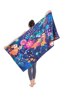 Detail of soft microfiber beach towel featuring colorful sloth and tropical flora pattern