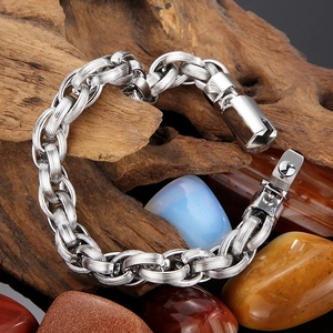 Mens heavy silver chain bracelet with industrial toggle clasp on wooden display