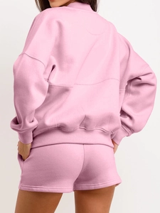 Women's pink two-piece tracksuit featuring a cropped long sleeve hoodie and matching shorts