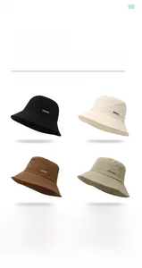 Detail of four foldable bucket hats in neutral tones with side metal logo branding