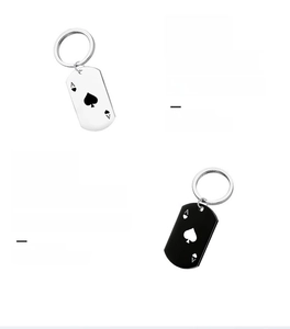 Detailed macro view of silver and black stainless steel playing card pendant keychains