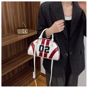 Fashionable red and white striped bowling bag with 02 decoration held by a model in blazer