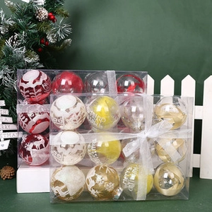 Assorted red and gold Christmas ornaments in a transparent gift box for tree decoration