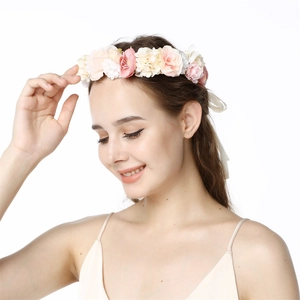 Detailed close-up of pink and white fabric flowers on a handmade bridal headpiece