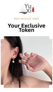 Detailed view of elegant pearl drop earring in 18K gold finish on model's ear