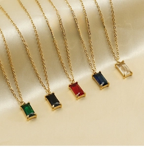 Detail view of five color square zircon pendants on gold stainless steel chains