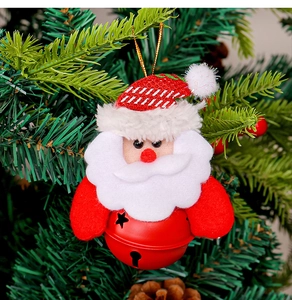 Detailed close-up of a Santa Claus bell ornament hanging on a green Christmas tree branch