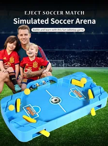 Close-up of tabletop soccer game with blue board and yellow ejection handles for kids
