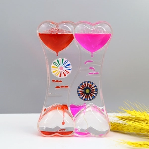 Close-up of double heart liquid motion bubbler timer with red and pink oil droplets
