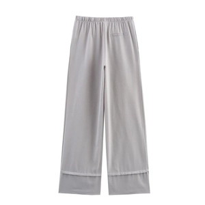 Detail of light grey linen wide-leg trousers with elastic waist and tailored back pocket
