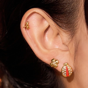 Three-piece gold insect stud earrings set with ladybug and dragonfly on model