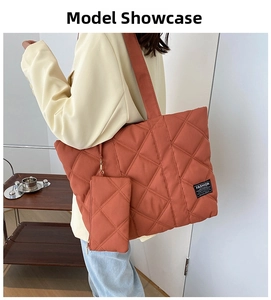 Brick red quilted nylon tote bag with matching mini pouch shown on female model