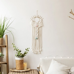Handmade macrame evil eye wall hanging with natural stones in a cozy living room decor
