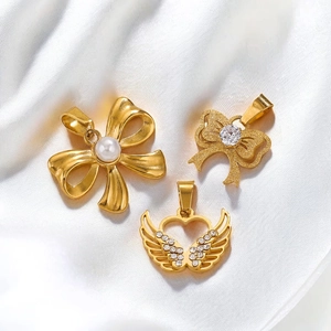 Elegant 18K gold plated stainless steel bow and winged heart pendants on white silk