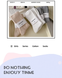 Close-up of cotton ribbed crew socks in beige white and grey with premium paper packaging