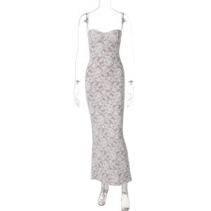 Close-up of intricate white floral lace patterns and nude lining on the slim long dress