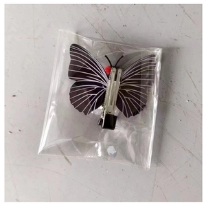Detail of a butterfly skull hair clip with white texture on a black duckbill hairbase