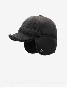 Detail of black winter aviator hat featuring faux shearling lining and metal snap button