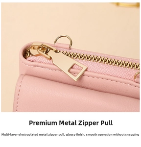 Close-up of premium light gold metal zipper and D-ring on soft pink leather crossbody bag