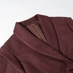Detail of classic notched lapel on a burgundy faux suede jacket with smooth lining