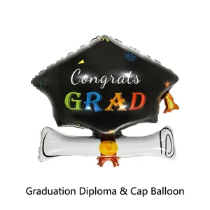 Detail of congrats grad graduation cap and diploma shaped foil balloon party decor