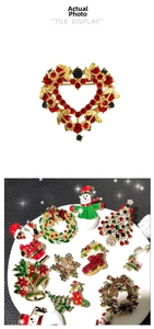 Detailed close-up of Christmas brooches with festive red and green crystal rhinestones