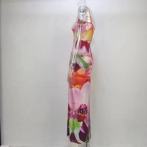 Side view of slim-fit floral maxi dress featuring a high slit and halter neckline