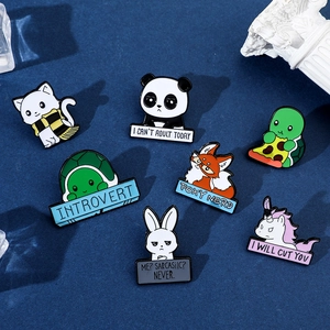 Flat lay of seven cartoon animal enamel pins with witty text on blue background