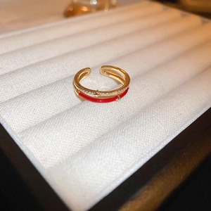 Macro shot of gold plated dragon ring with red enamel and pavé zircon details