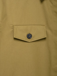 Detail of khaki cargo short sleeve shirt showing buttoned pocket and fabric texture